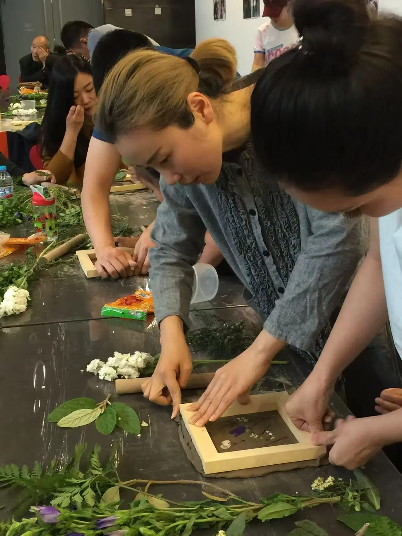 Hands and materials gathered around a participatory workshop table